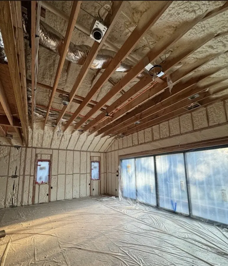 Interior walls and ceiling insulated with spray foam during new construction in Atchison